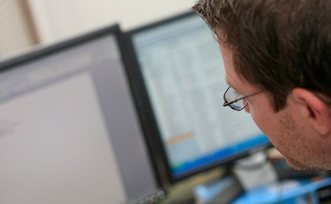 Developer looking at code on a screen